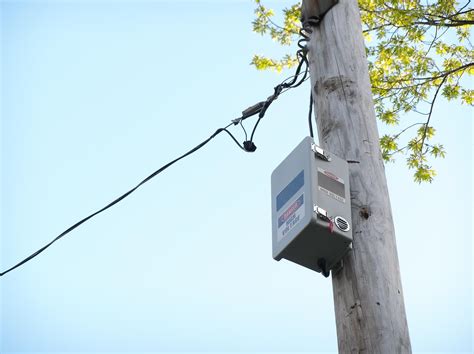 black box on electric poles|town's utility pole boxes.